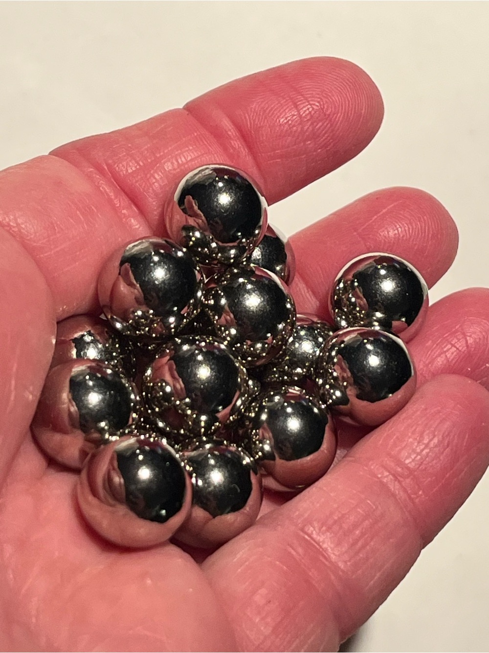 16 silver tone balls or beads. These are 7mm balls and they weigh 3.78 grams.